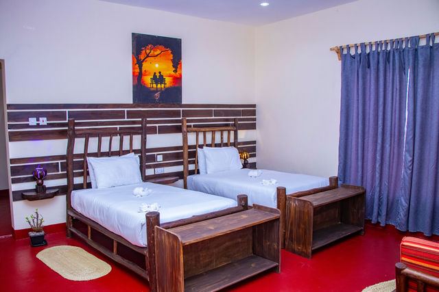 Twin room with carved wooden bed frames